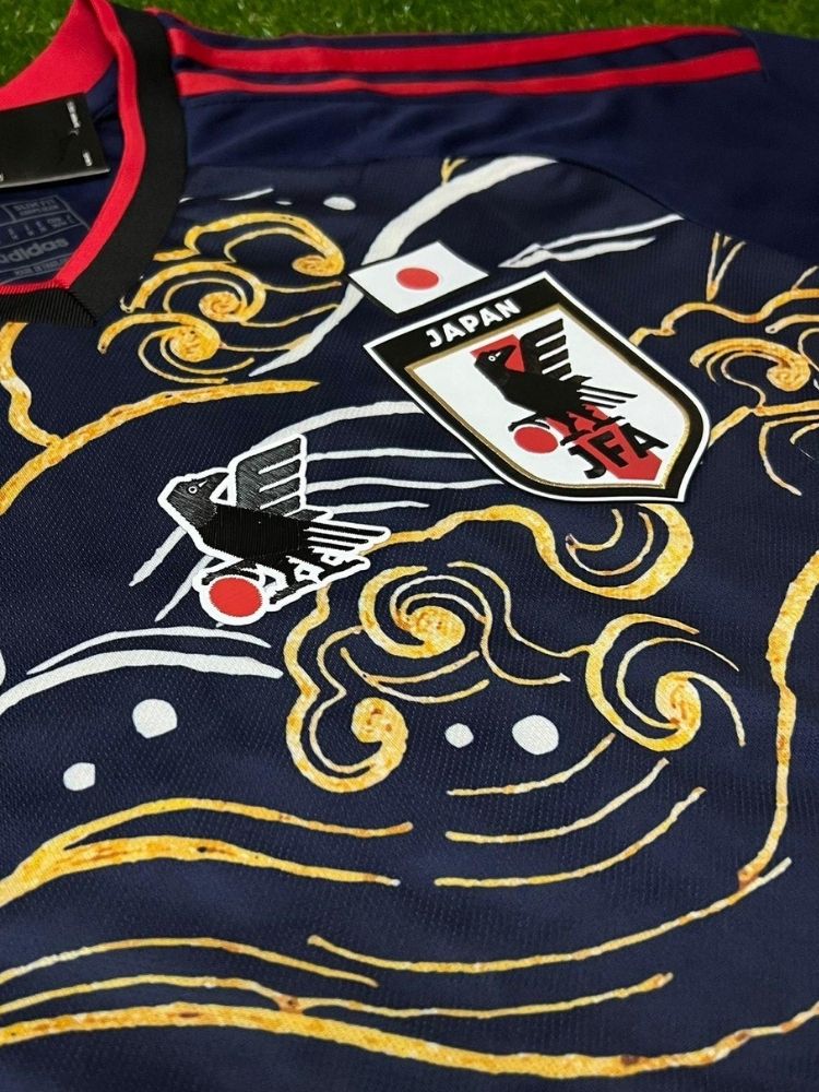 Maillot du Japon Black Waves avec vagues de Kanagawa dorées et corbeau sur fond noir, symbolisant la culture et l'art japonais en football.